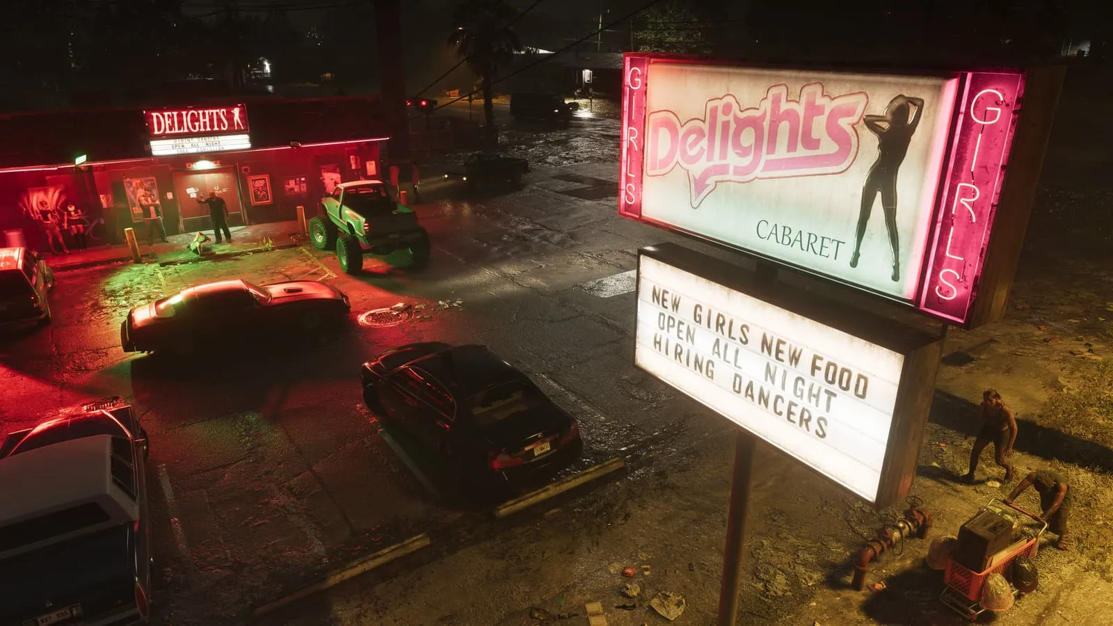 Panneau lumineux du cabaret Delights et son parking mouillé de nuit, façade néon rouge en face